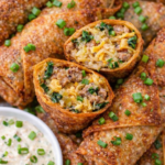 Crispy Irish sausage egg rolls filled with sausage, sauerkraut, and Irish cheddar served with creamy horseradish dipping sauce and green onions