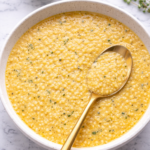 Creamy Italian penicillin soup with acini di pepe pasta in a white bowl on a marble countertop