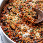 one pan eggplant parmesan stir fry in stainless skillet with melted cheese and toasted breadcrumbs