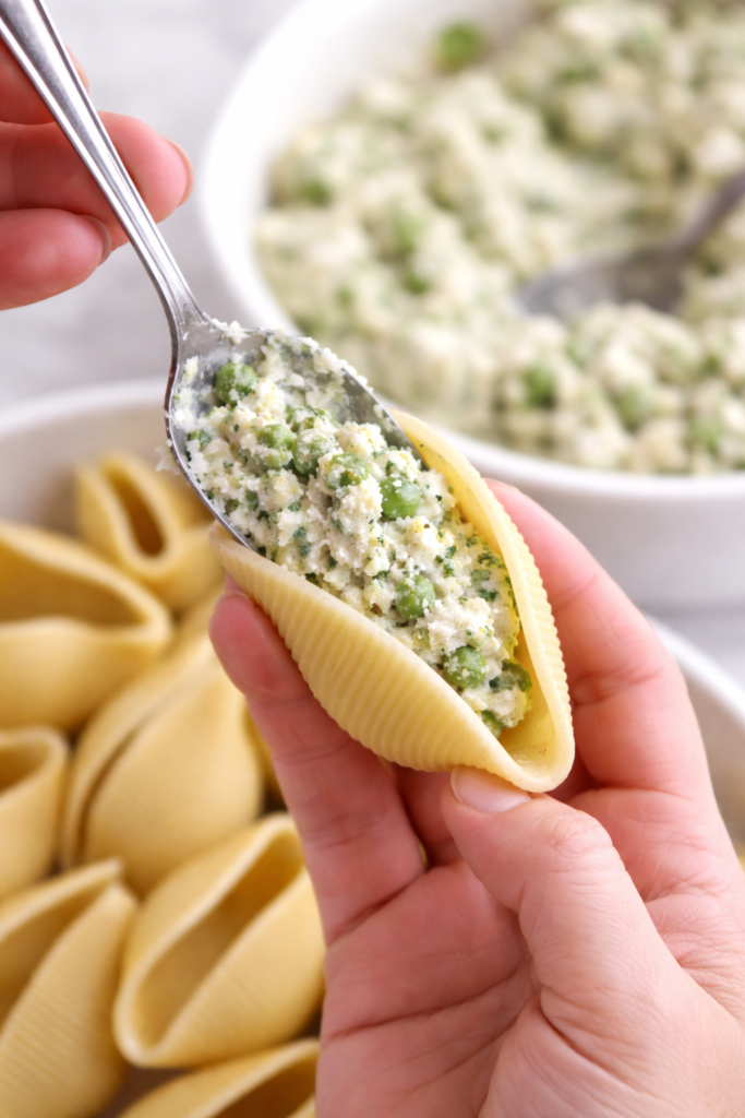 filling stuffed shells with creamy ricotta mixture