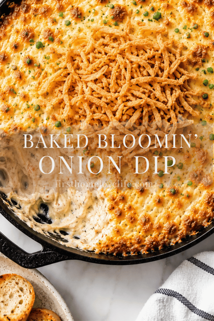 Creamy baked Bloomin’ Onion Dip topped with crispy fried onions in a cast iron skillet