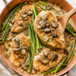 This easy Cheesecake Factory Chicken Madeira features tender chicken breasts, mushrooms, asparagus, and a rich Madeira wine sauce all cooked in a vintage copper skillet.