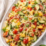Fresh farmer’s market spaghetti salad with cherry tomatoes, zucchini, peaches, corn, basil, cilantro, Parmesan, and Italian vinaigrette