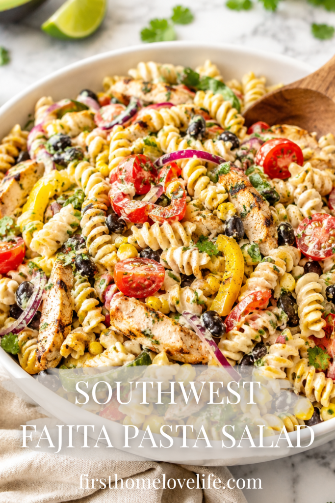 Southwest fajita pasta salad with grilled chicken, black beans, corn, tomatoes, peppers, and rotini pasta in a creamy dressing served in a white bowl.