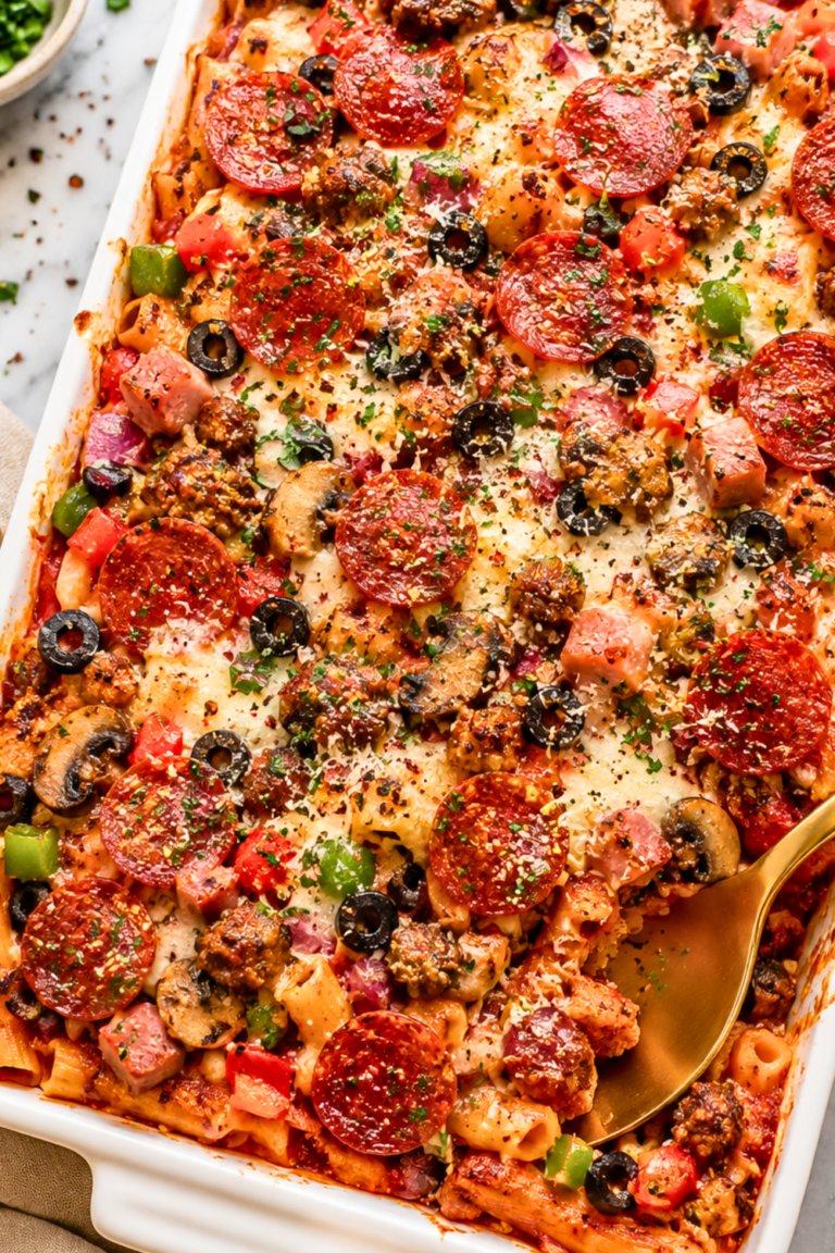 Cheesy Supreme Pizza Pasta Bake Casserole with pepperoni, sausage, Canadian bacon, mushrooms, black olives, bell peppers, marinara sauce, and melted mozzarella cheese in a white casserole dish.