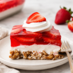 Classic strawberry pretzel salad with a crunchy pretzel crust, cream cheese filling, fresh strawberries, and strawberry gelatin