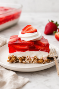 Classic strawberry pretzel salad with a crunchy pretzel crust, cream cheese filling, fresh strawberries, and strawberry gelatin