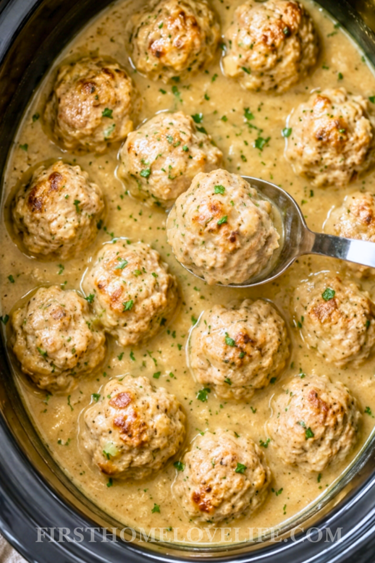 Homemade Crockpot chicken and stuffing meatballs cooked in creamy chicken gravy with fresh parsley.