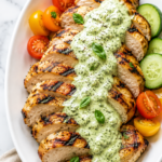 Sliced grilled chicken topped with creamy garlic basil dressing and served with cherry tomatoes and cucumbers.