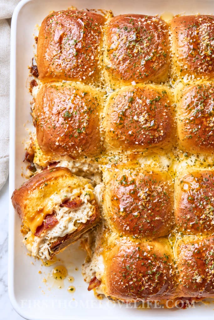 Baked hot honey chicken sliders with bacon, ranch and melted cheddar cheese on buttery Hawaiian rolls.