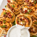 Jalapeño popper smash burger skewers filled with ground beef, cream cheese, cheddar, bacon, and jalapeños dipped into ranch dressing.