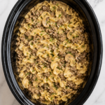 Slow Cooker Hamburger Helper Beef Stroganoff with ground beef, mushrooms and egg noodles in a black crockpot