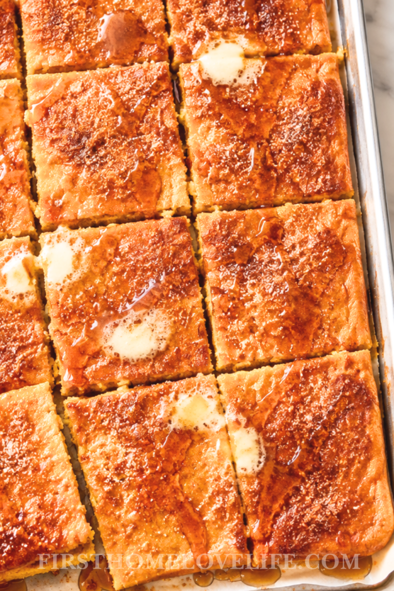 Pumpkin sheet pan pancakes cut into squares and drizzled with melted butter, maple syrup, and cinnamon sugar