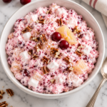 Classic cranberry marshmallow salad with fresh cranberries, pineapple, mini marshmallows, and chopped pecans in a white bowl.