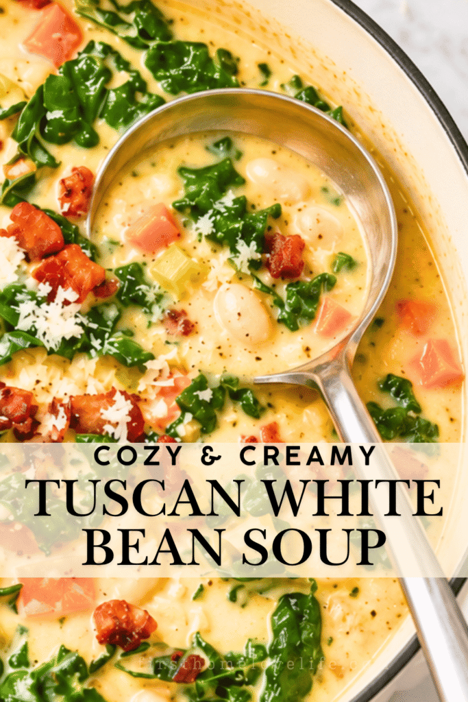 Creamy Tuscan white bean soup with bacon, kale, carrots, and Parmesan in a white enamel Dutch oven.