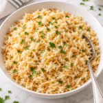 Homemade Rice-A-Roni with toasted vermicelli and parsley in a white bowl.