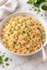 Homemade Rice-A-Roni with toasted vermicelli and parsley in a white bowl.
